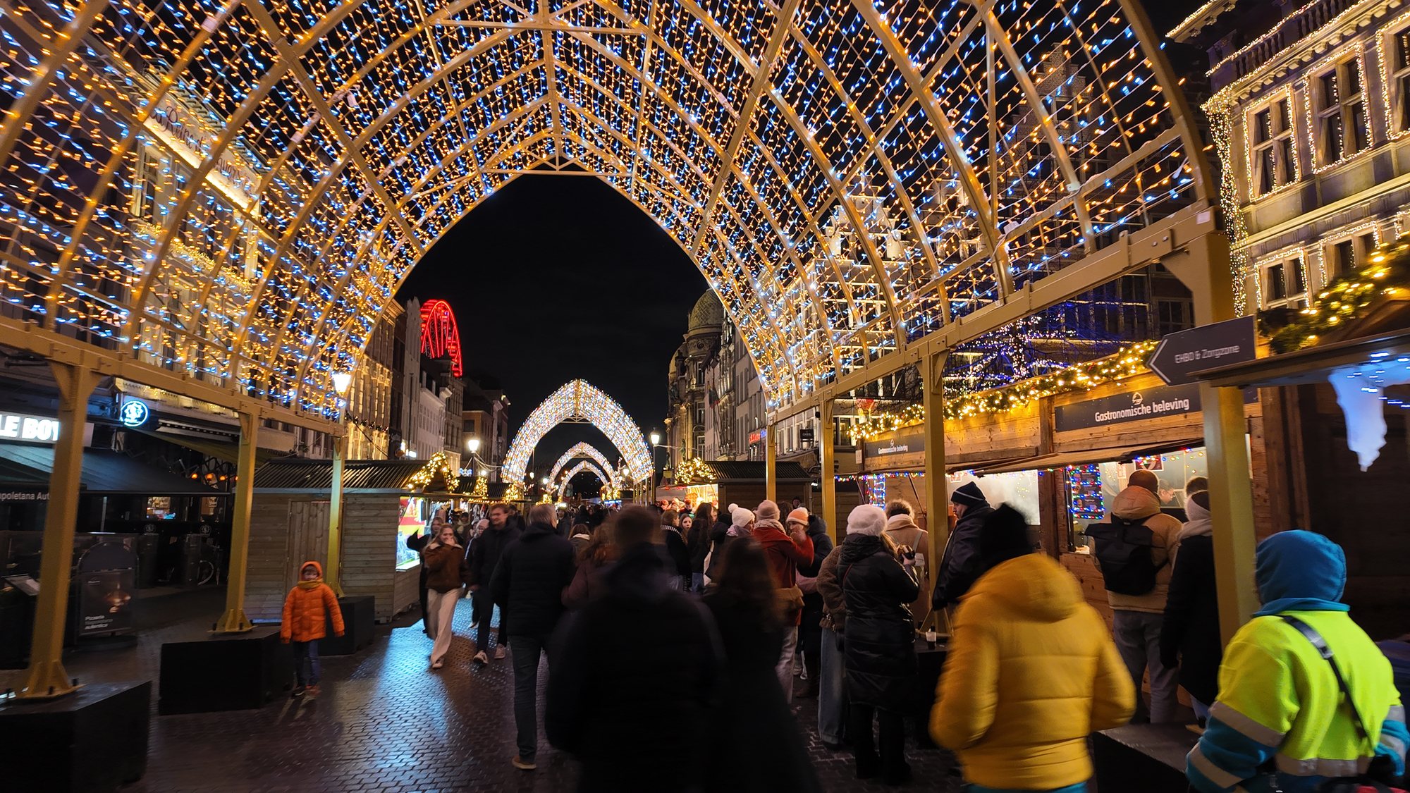 Illuminated arch tunnel over Antwerp's Christmas market